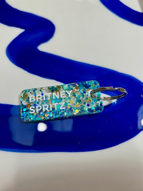 Porte clés à paillettes - Britney Spritz - Bleu/or/vert